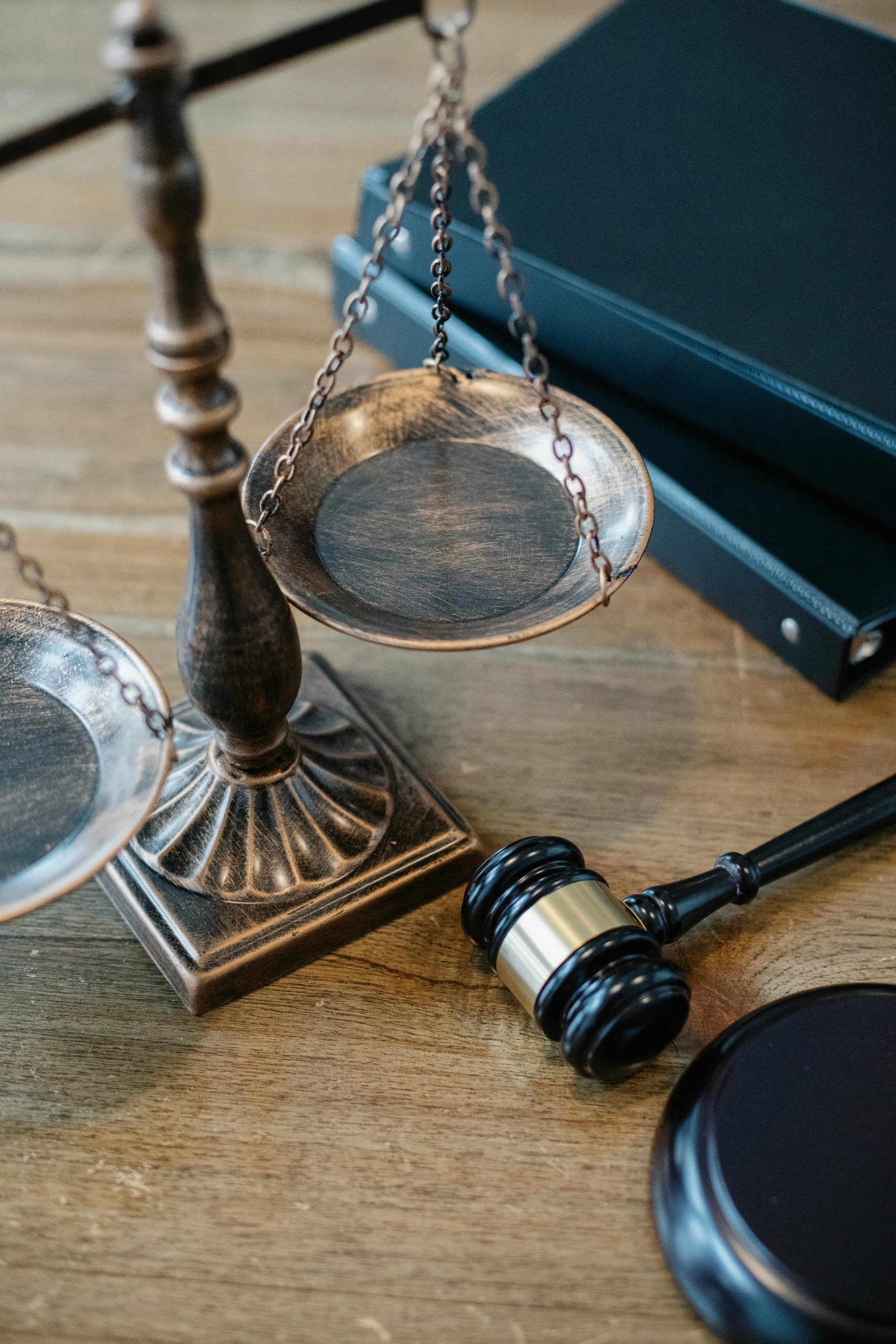 A set of bronze scales and a gavel on a table